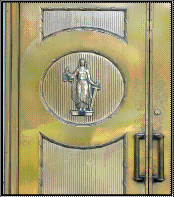 Image starts. Double metal doors with figure of a woman holding a sword in one hand and a scale in the other on the middle of one door. Image ends. 