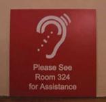 Description: Sign directing person who are hearing impaired to "Please see Room 324 for Assistance.